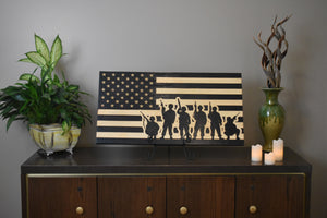 Staged photo of flag with engraving a group of soldiers