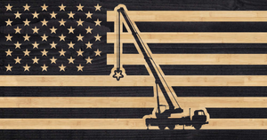 Crane hoisting one of the stars from the American flag into position.