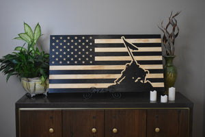 Staged photo of flag with engraving of soldiers raising the flag at Iwo Jima
