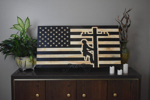 Staged photo of flag with engraving of a line worker