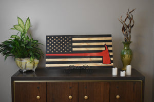 american flag with engraving of red firefighter's ax, charred wood flag