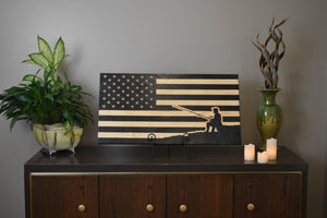 Staged photo of flag with engraving of a fisherman relaxing on the shore